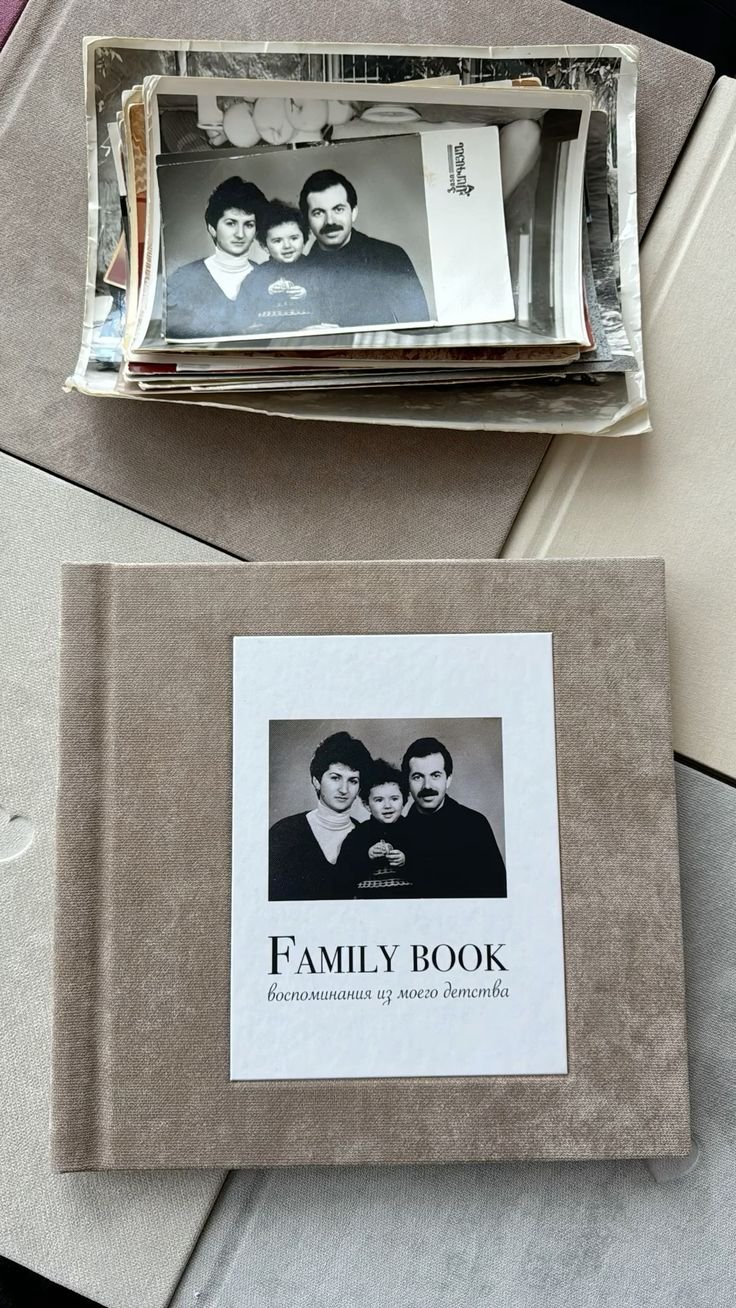Vintage photography prints arranged above a family photo album